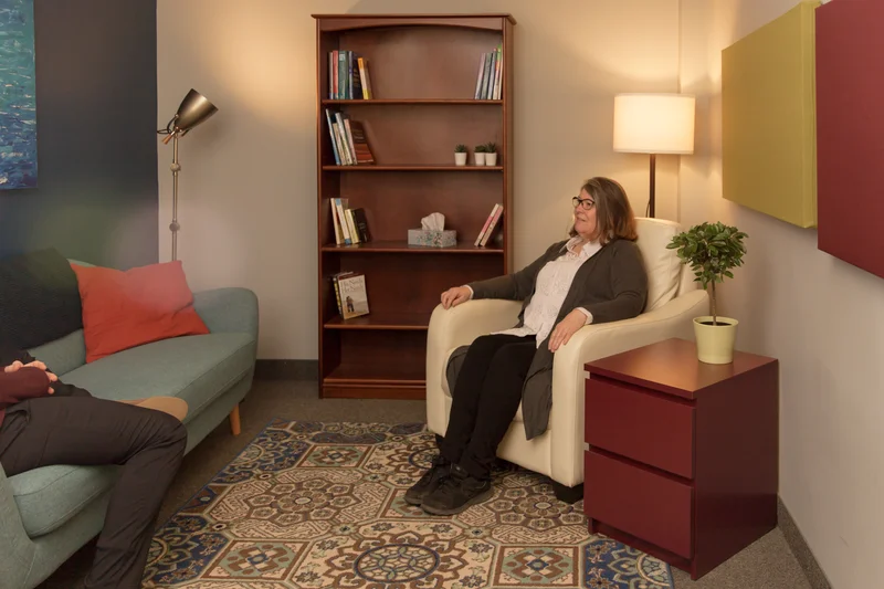 First Nations therapy session in a comfortable Belleville office featuring a therapist and client in a supportive environment.