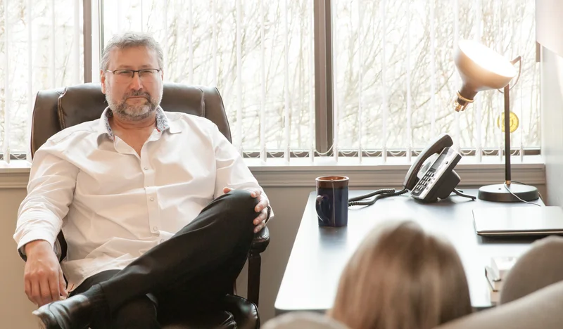 Indigenous therapy provider in Belleville Ontario sitting in a professional office setting during a consultation.